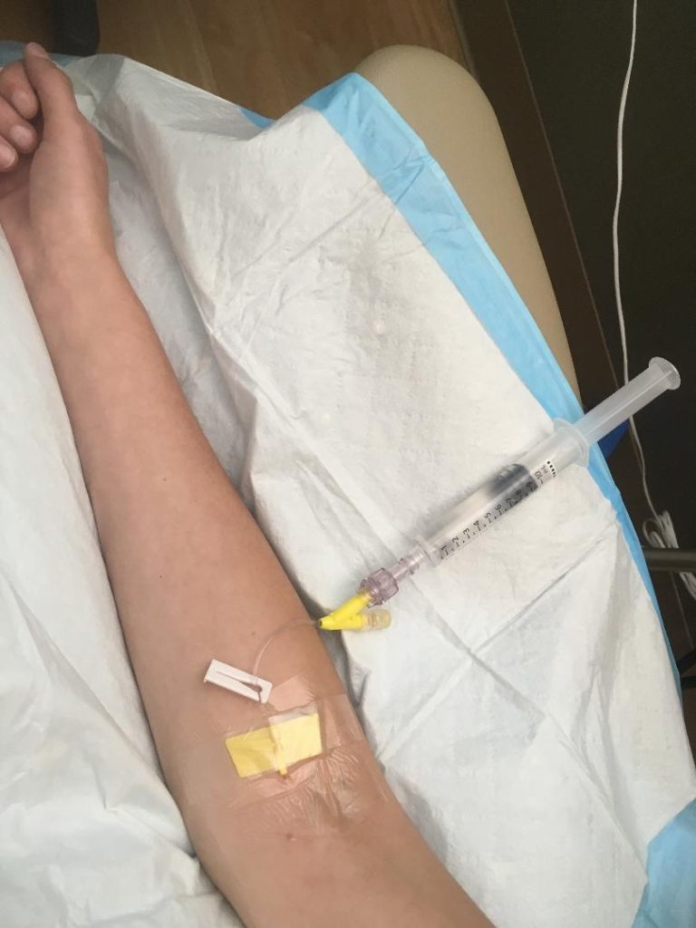 Syringe of Benadryl getting pumped into Jenna's veins through the IV