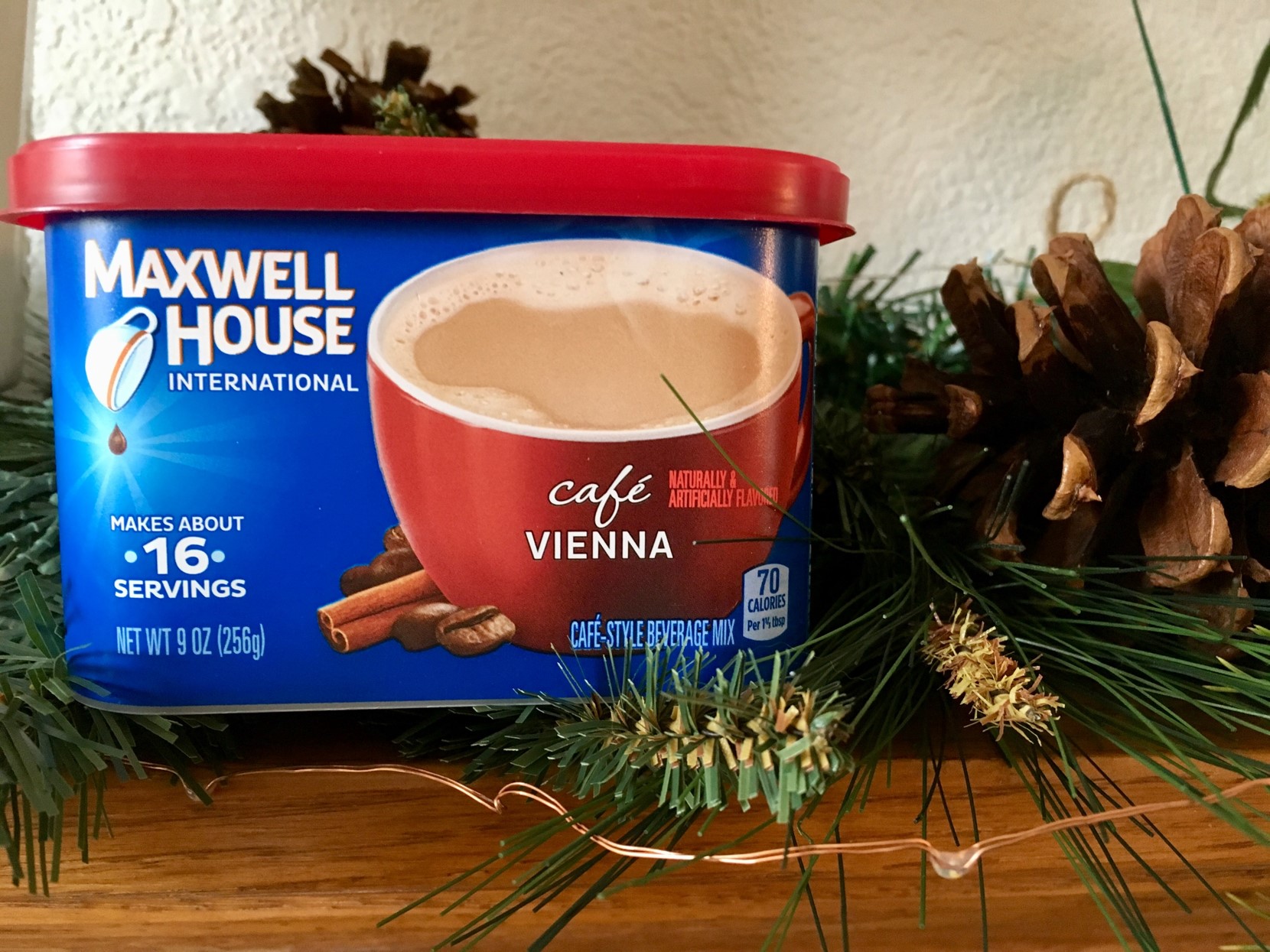 Box of Maxwell House instant coffee on mantle next to Christmas decorations