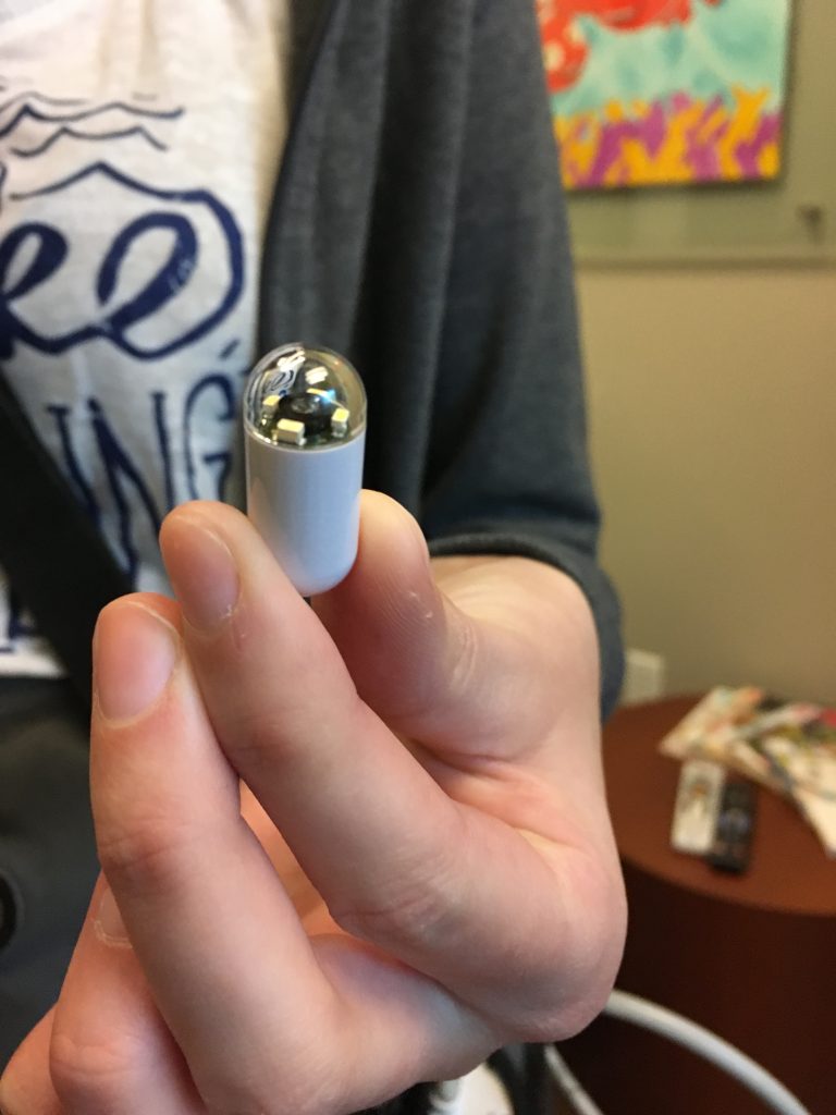 Close up of me holding capsule.
